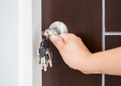 Locking or unlocking door with key by hand